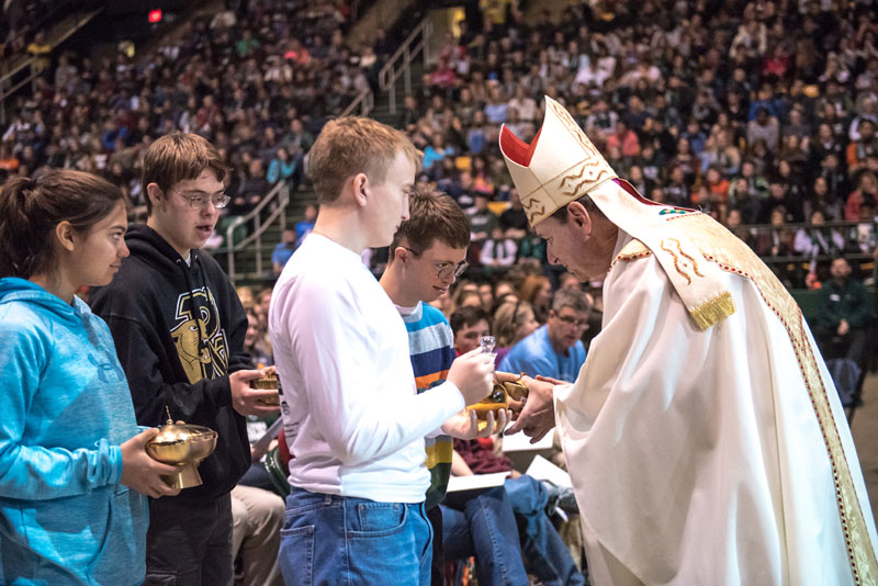 Students form Paul VI High School bring forth the gifts